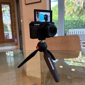 Canon Black Compact Camera with Black Manfrotto Mini Tripod